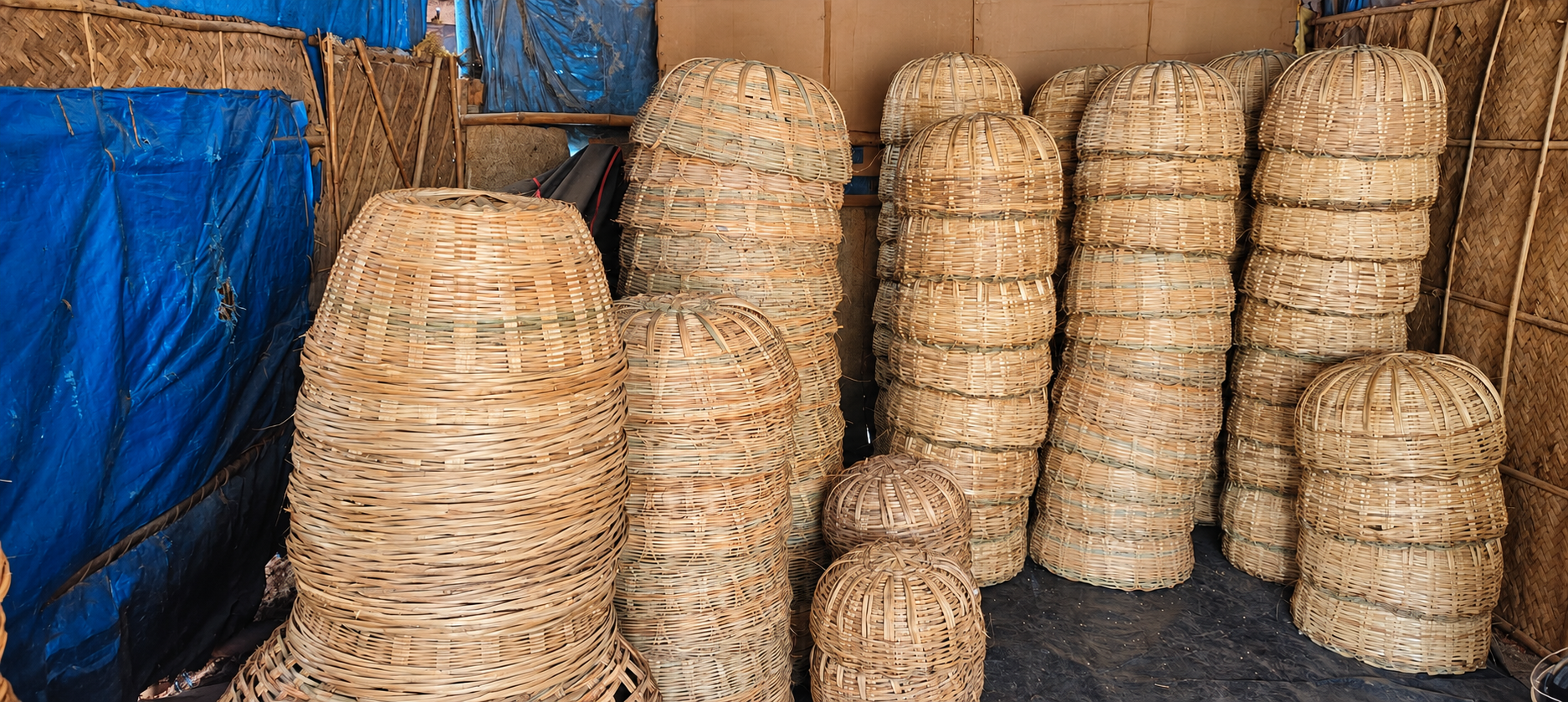 Woven baskets stacked inside the Sri Balaji Bamboo Works workshop
